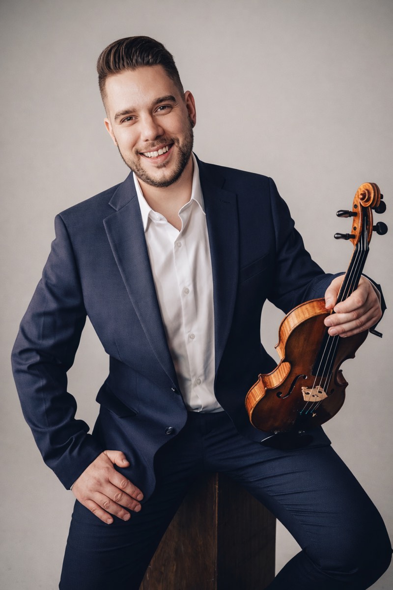 Professional portrait of Anthony Sabberton holding a violin